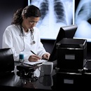 Physician writing a prescription for a patient Physician writing a prescription for a patient