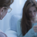 Nurse talking to a patient struggling with mental health Nurse talking to a patient struggling with mental health