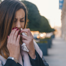 Woman using Zicam nasal spray Woman using Zicam nasal spray